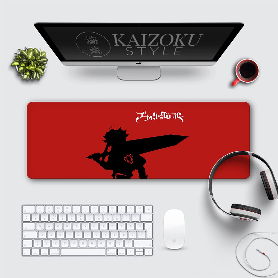 A bold anime desk mat featuring Asta from Black Clover. The design showcases a striking black silhouette of Asta wielding his sword, set against a vibrant red background. The mat includes the Black Clover logo in Japanese, adding an authentic touch. A perfect accessory for anime enthusiasts and fans of Asta's indomitable spirit.